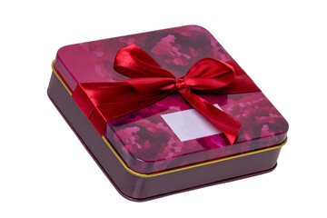 Closeup of a decorative red pink present or gift box with ribbon bow isolated on a white background. Birthday, Christmas, Valentine's Day. Clipping path. Macro.