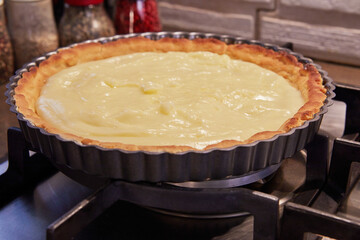 Kiwi pie, with cream during cooking. French gourmet cuisine