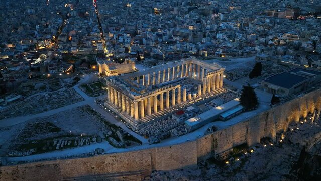 night view of Acropolis in Athens, flying above illuminated Parthenon in Athens in the evening, night view of downtown Athens, international landmark in Greece
