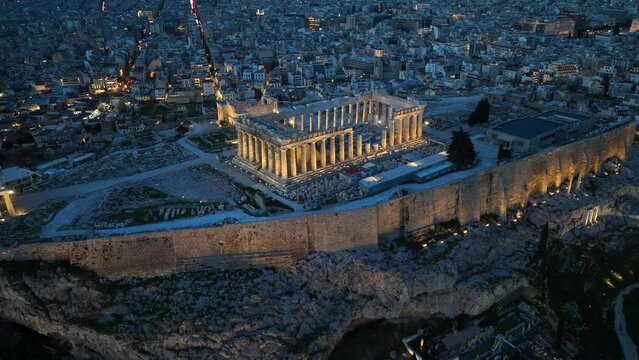 Acropolis in Athens at night, flying above illuminated Parthenon in Athens in the evening, night view of downtown Athens, international landmark in Greece