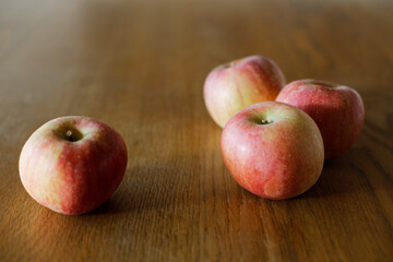 Fuji apples on wooden dining table. Space for copy.