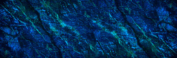 Toned stone texture. It looks like a marble surface. Navy blue background with copy space for design. Wide banner. Panoramic.