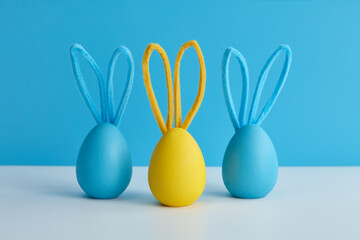 Blue and yellow Easter eggs with bunny ears, holiday decoration