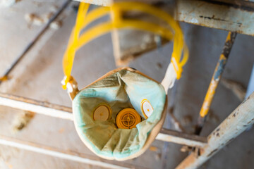 Construction respirator U-2K half mask hanging on scaffolding close-up - obrazy, fototapety, plakaty