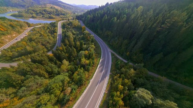 FPV drone view magnificent open landscape wild natural environment scenery wood wildlife forest mountains on bright day. Maneuverable flight. Aerial cinematic video.