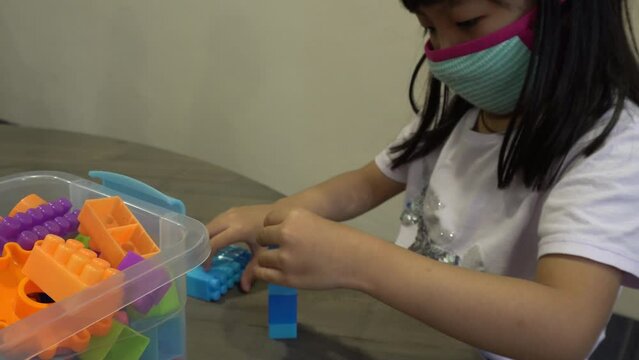 A kid segregate the ABC block in different color.