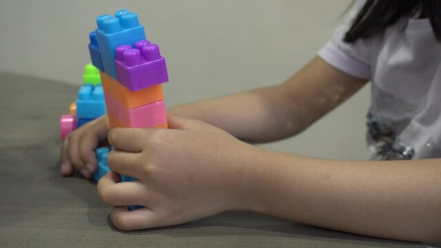 A little girl separate education ABC block. Preschool activity