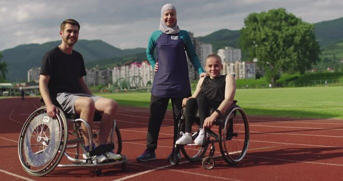 Hero portrait shot of disabled sport people whit female trainer wearing hijab after training on athletics sports track. 