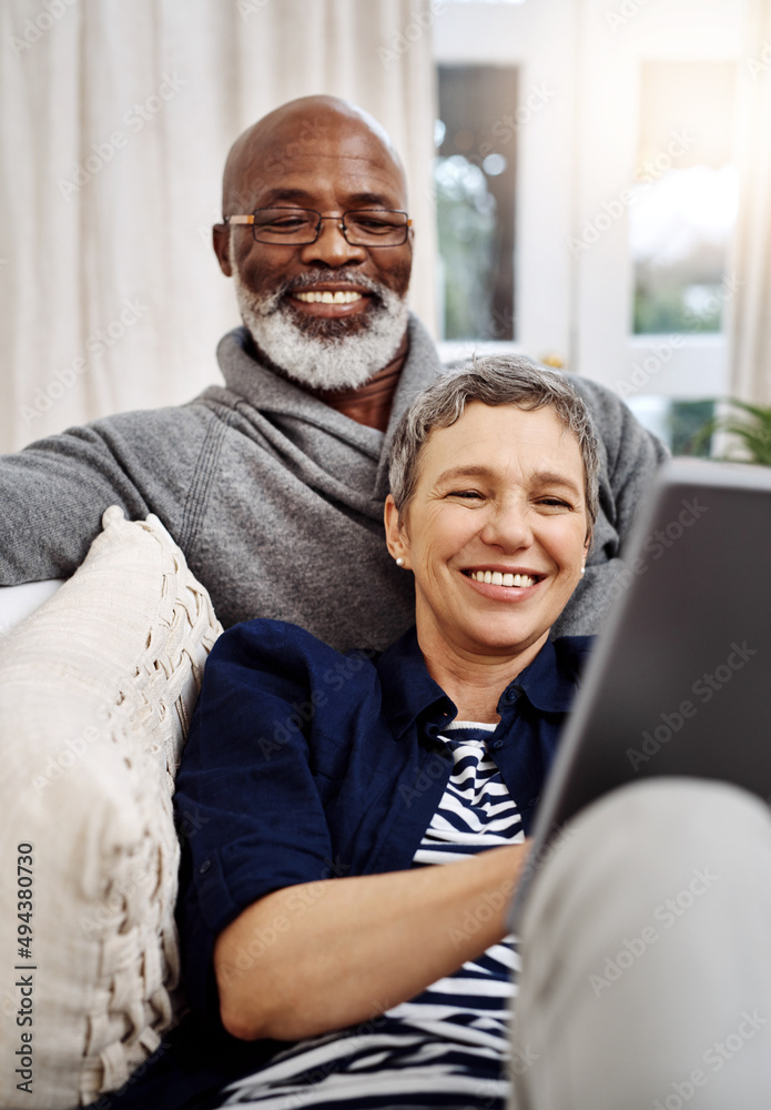Aufkleber were having a wonderful weekend indoors. shot of an affectionate senior couple using a tablet while 