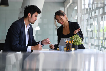 Confident hr manager talking and introduction company to male applicant.