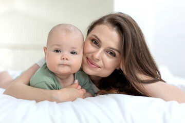 Mom and baby. Beautiful woman with a baby at home. High quality photo