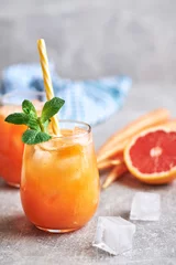 Foto op Plexiglas Carrot juice served in glass. Fresh carrot juice served in glass on table. Carrot healthy juice for detox. © Mihailo