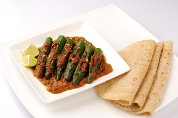 Indian style Masala Sabji OR Sabzi of fried Bhindi OR Okra also known as Ladyfinger  with chappati