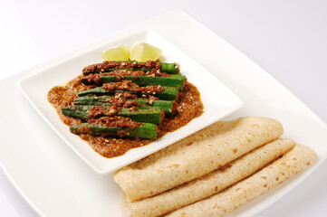 Indian style Masala Sabji OR Sabzi of fried Bhindi OR Okra also known as Ladyfinger  with chappati