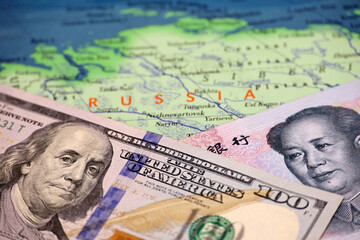 Chinese yuan and US dollar on the map of Russia. Concept of economic cooperation between the Beijing and Moscow during american sanctions due conflict in Ukraine