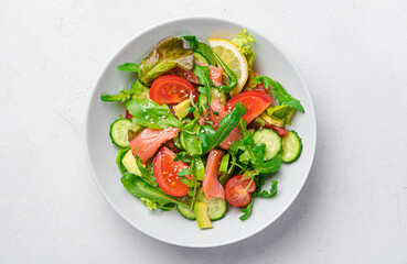 Salad with salmon, avocado, tomatoes, fresh herbs and sesame flax seeds.