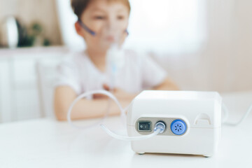 Nebulizer in front of little boy with mask on his face.