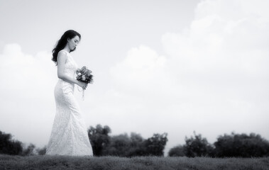 Beautiful tender bride wearing dress in wedding atelier.