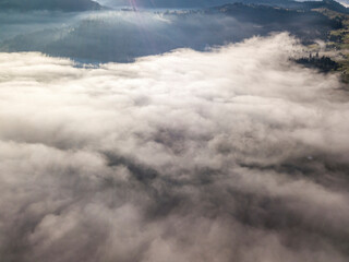 Morning mist in Ukrainian Carpathian mountains. Aerial drone view.