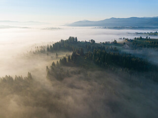 Morning mist in Ukrainian Carpathian mountains. Aerial drone view.