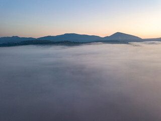 Morning fog in the Ukrainian Carpathians. Aerial drone view.