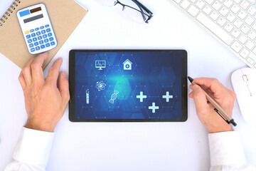 Medical business graph and data on lablet, investment, financial and banking, and medical business report on worldwide network