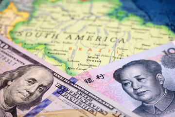 US dollar and Chinese yuan on the map of Brazil. Economic competition between the China and USA in Latin America countries