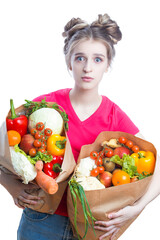 Healthy Lifestyle. Embarrassed Caucasian Blond Girl Holding Two Eco Paper Bags with Vegetables and Groceries And Thinking On White Background.