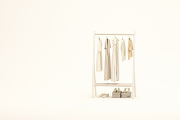Clothes hanging on a rack, shelf on pastel beige background. Creative composition. Light background with copy space. 3D render for web page, presentation, studio, store fashion
