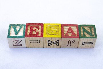 The term VEGAN displayed visually on a clear background with copy space