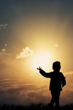 small child playing with the sun

