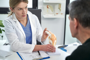 Female caucasian doctor talking with her patient