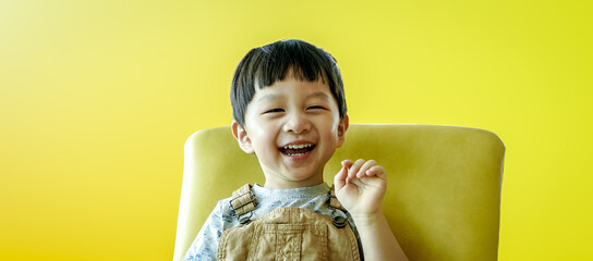 Portrait of happy smiling child boy isolated on yellow background. Portrait of happy joyful laughing beautiful little boy on yellow background.