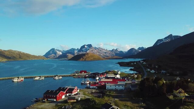 Small fishing village of Hamnoya on Lofoten islands in Norway, popular tourist destination with its typical red houses and natural beauty. Red houses in Norway on the Lofoten Islands.