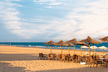 empty terrace bar on the sand of the beach by the sea at sunset. Guardamar, Alicante. Spain
