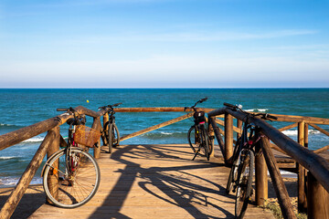 Fototapeta premium group of bicycles parked on a footbridge by the sea. No people