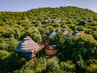 couple men and woman by the pool on a luxury safari,South Africa Kwazulu natal, luxury safari lodge...