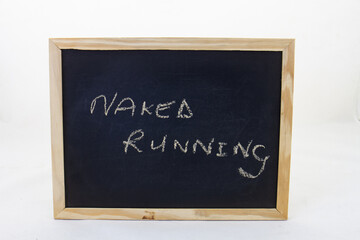 Obraz premium The term NAKED RUNNING written on a blackboard
