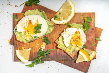 Healthy diet sandwiches for breakfast, snack. Toast with guacamole avocado salsa and poached egg 