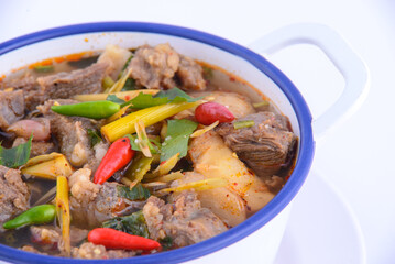 Thai favorite food. Spicy chicken soup (Tom Yum Gai Baan) in the white bowl.