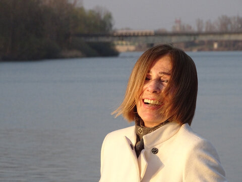 Senior Elegant Caucasian Short Haired Blond Woman Outdoors In A Park At Sunset - Aging Well Concep