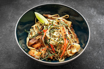 Spaghetti with seafood on a dark background