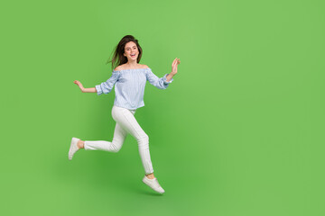 Fototapeta na wymiar Photo of playful fooling woman wear plaid off-shoulders blouse jumping high running empty space isolated green color background