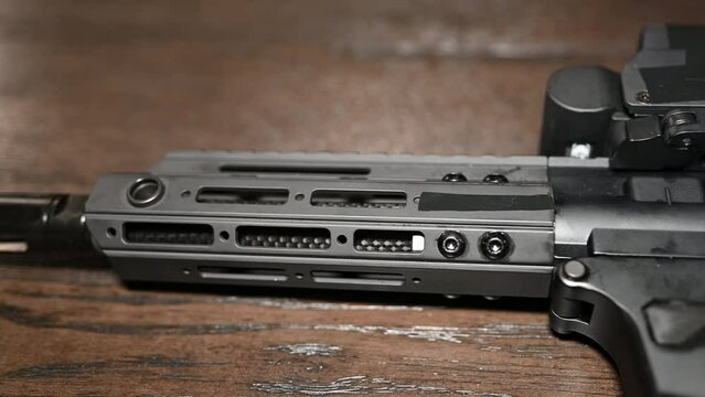 left to right slide over a AR style 9mm personal protection weapon with holographic sight optic