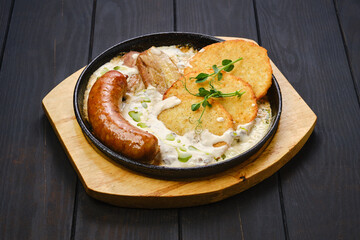 Potato fritters with with fried sausage and pork belly