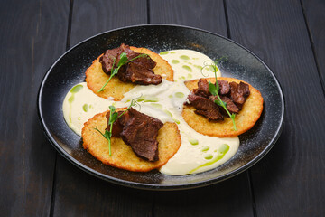 Potato fritters with with fried beef