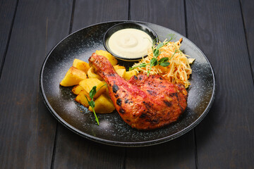 Roasted chicken thigh with potato wedges and pickled cabbage
