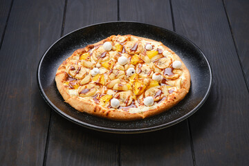 Sweet pie with banana, orange, cranberry and caramel syrup