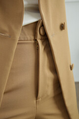Close up image of beige tailored suit.
