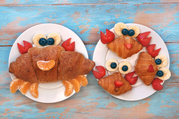 Fun idea for kids breakfast. Cute crab croissant with berries and fruits. Fun food for children.